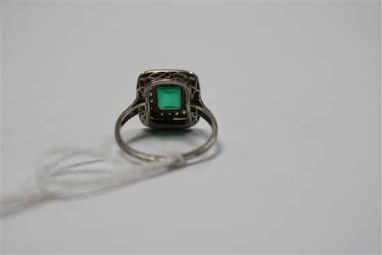 A white metal, emerald and diamond tablet cluster ring, size K.